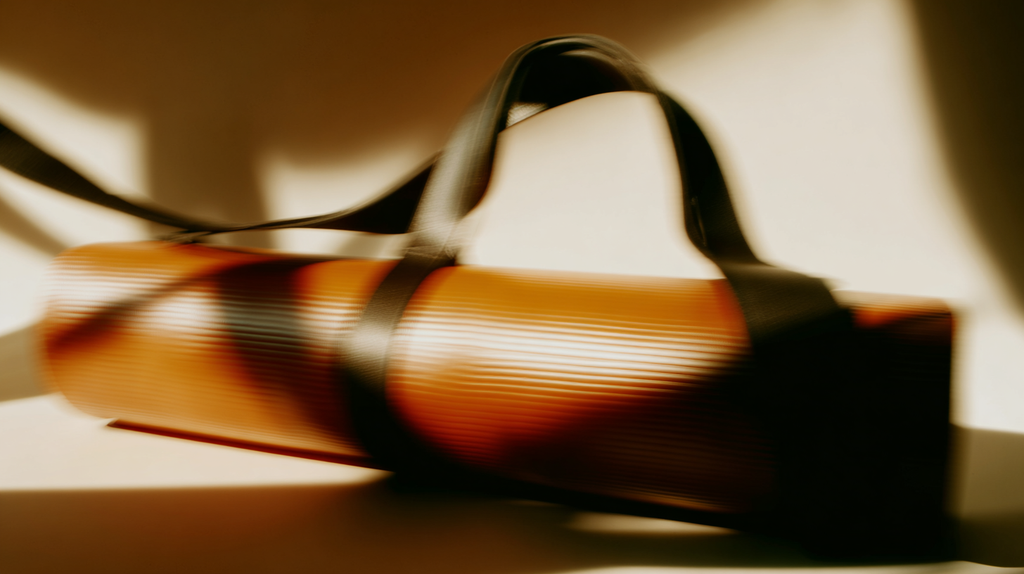 Luxury yoga mat strap with black handles and sculptural light – sustainable mat carrier designed for elegant, conscious movement